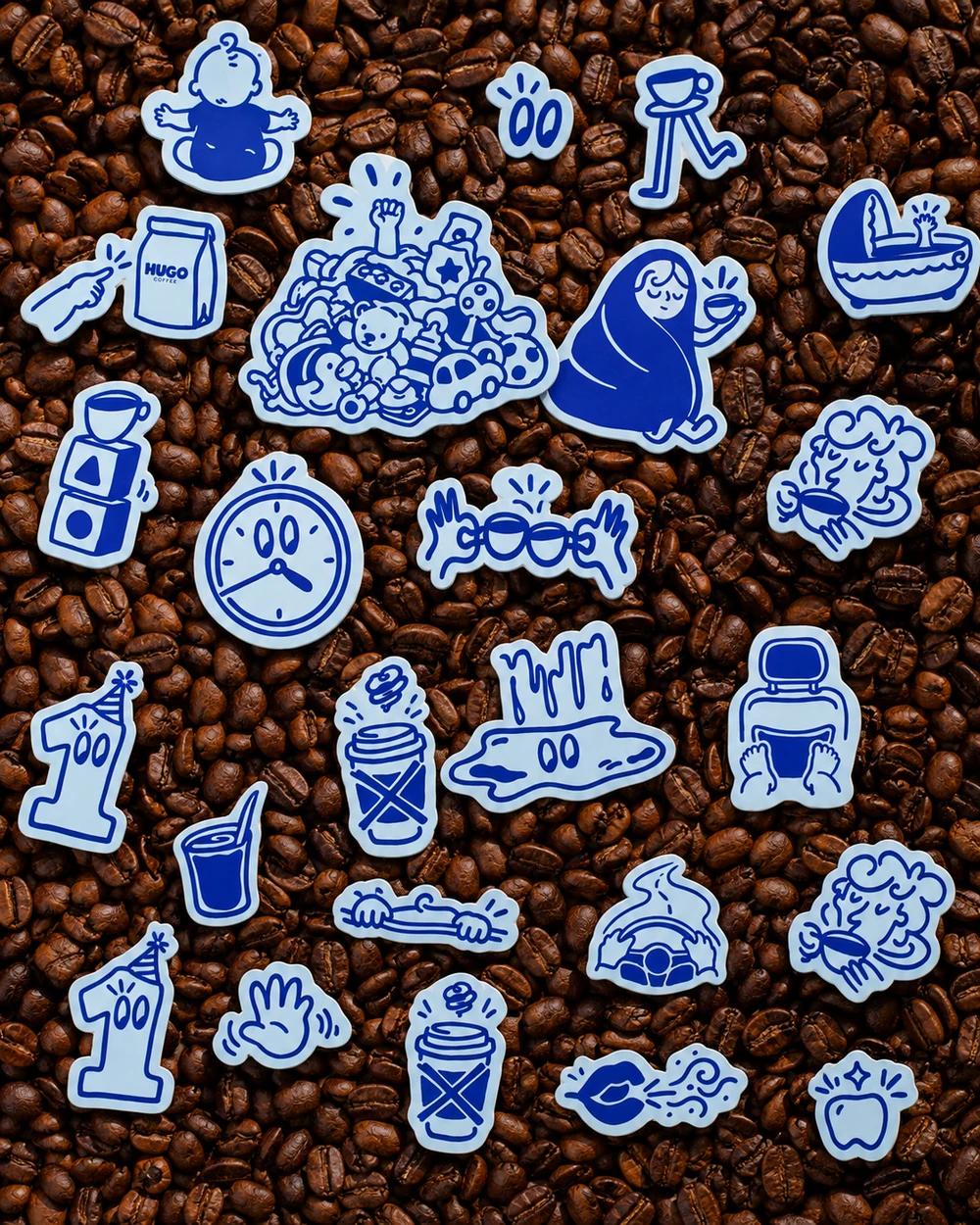 Hugo stickers scattered over coffee beans